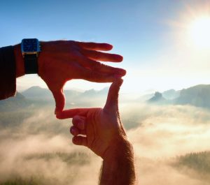 Close,Up,Of,Hands,Making,Frame,Gesture.,Blue,Misty,Valley